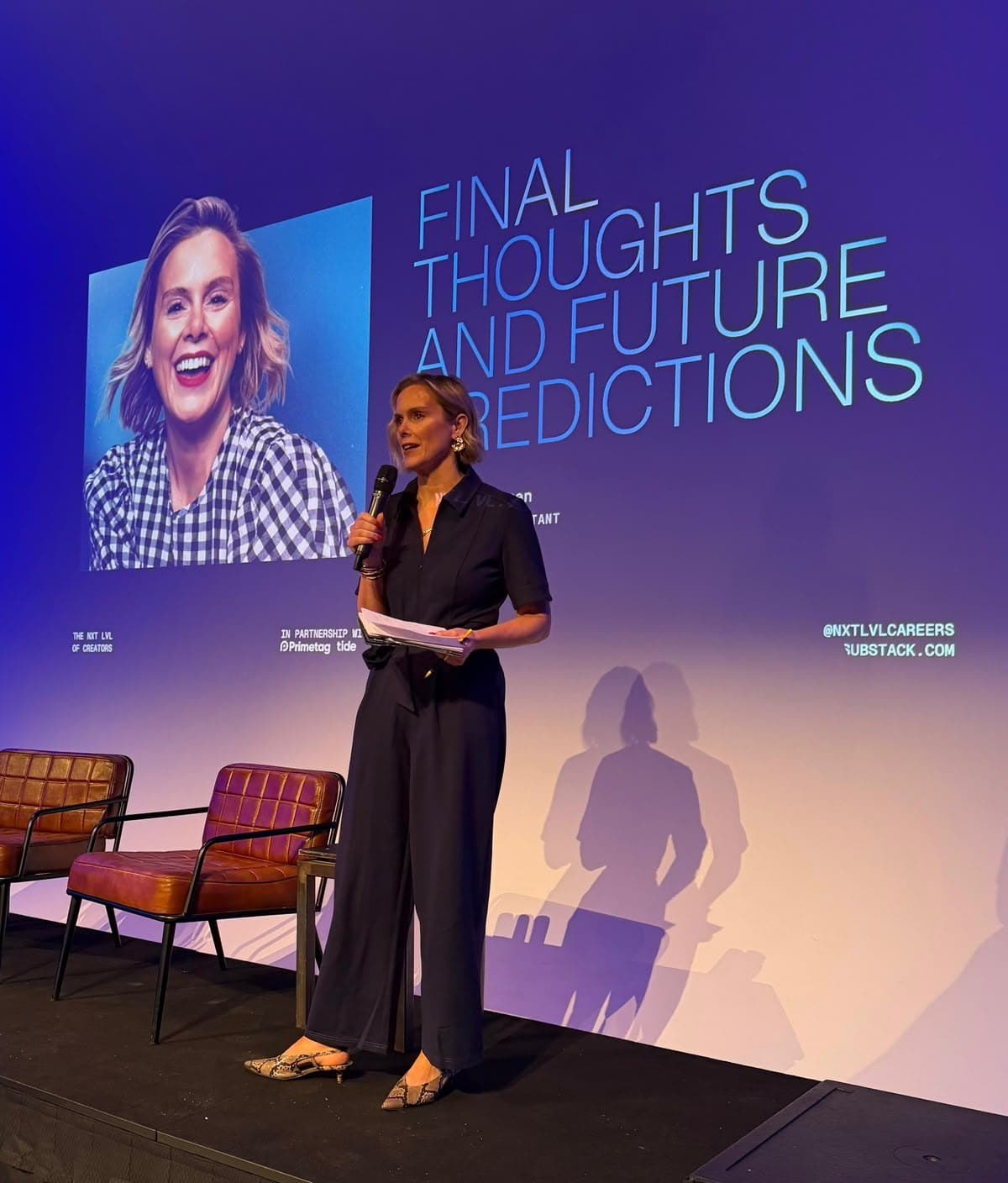 Lauren Spearman speaking on stage, microphone in hand
